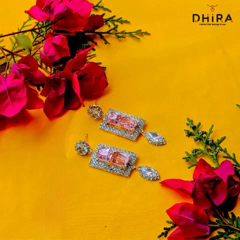 Elegant crystal pink gemstone earrings with diamond accents on yellow background, floral decor