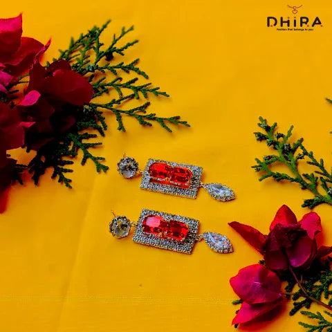Rectangular red crystal earrings with rhinestones on yellow background, floral decor
