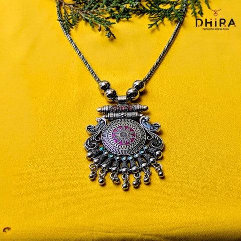 Oxidized silver ethnic pendant necklace with pink floral design on yellow background